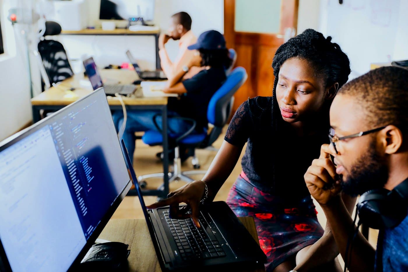 Two students reviewing something together on a laptop